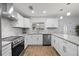 A well-lit kitchen with stainless steel appliances, quartz countertops, and stylish tile backsplash at 2333 Indigo Dr, Clearwater, FL 33763