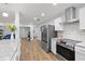 The shot exhibits the layout of the updated kitchen looking into the dining and living room areas at 2333 Indigo Dr, Clearwater, FL 33763