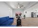 Bright living room with wood-look tile flooring, modern ceiling fan, and open access to other living spaces at 2333 Indigo Dr, Clearwater, FL 33763