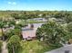 Beautiful waterfront home with mature trees, tile roof, and screened-in lanai at 2401 Roberta Ln, Clearwater, FL 33764