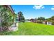 Expansive lawn extending to the waterfront, complemented by lush landscaping and a private dock at 2401 Roberta Ln, Clearwater, FL 33764