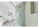 Bathroom featuring new patterned tile floor, modern vanity, and shower with light green tile at 2401 Roberta Ln, Clearwater, FL 33764