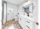 Bathroom featuring decorative tile flooring, modern vanity, and updated fixtures for a stylish touch at 2401 Roberta Ln, Clearwater, FL 33764