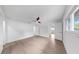 Airy bedroom with natural light, neutral flooring, and modern ceiling fan for added comfort at 2401 Roberta Ln, Clearwater, FL 33764