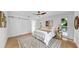 Bright main bedroom with a sliding barn door and modern interior design at 2401 Roberta Ln, Clearwater, FL 33764