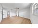 Bright bedroom featuring new flooring, a modern ceiling fan, and crisp white walls and trim at 2401 Roberta Ln, Clearwater, FL 33764