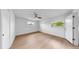 Bright bedroom featuring neutral flooring, closet space, and a modern ceiling fan for added comfort at 2401 Roberta Ln, Clearwater, FL 33764