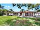 A beautiful single-story home with lush front yard, and classic architectural details at 2401 Roberta Ln, Clearwater, FL 33764
