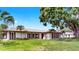 Beautiful single-story home with a spacious front yard and mature palm trees at 2401 Roberta Ln, Clearwater, FL 33764