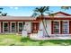 Charming home with a red tile roof, red shutters, and gated entry at 2401 Roberta Ln, Clearwater, FL 33764