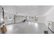 Bright, oversized garage featuring windows, epoxy floors, and a white sectional door at 2401 Roberta Ln, Clearwater, FL 33764