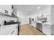 Bright modern kitchen featuring stainless steel appliances, white countertops, and contemporary cabinetry at 2401 Roberta Ln, Clearwater, FL 33764