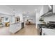 Open-concept kitchen boasts stainless appliances, quartz countertops, and stylish pendant lighting overlooking the living area at 2401 Roberta Ln, Clearwater, FL 33764