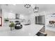 Modern white kitchen with stainless steel appliances, white cabinets and a large center island with bar seating at 2401 Roberta Ln, Clearwater, FL 33764