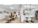 Open concept layout: Kitchen with breakfast bar flows seamlessly into the dining area and living room at 2401 Roberta Ln, Clearwater, FL 33764
