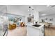 Cozy living room and kitchen view featuring modern pendant lights, comfortable seating, and an open, inviting design at 2401 Roberta Ln, Clearwater, FL 33764