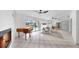 Spacious living room with fireplace, piano, and tile floor, opening to an outdoor pool area at 2401 Roberta Ln, Clearwater, FL 33764