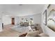 Bright living room with large windows, neutral furniture, and stylish decor creating a welcoming atmosphere at 2401 Roberta Ln, Clearwater, FL 33764