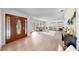 Bright and airy living room showcasing wood floors, a decorative front door, and neutral décor at 2401 Roberta Ln, Clearwater, FL 33764