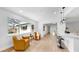 Cozy living room featuring modern chairs, large windows, and an open flow to the dining area at 2401 Roberta Ln, Clearwater, FL 33764