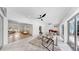 Large living room with fireplace, tile floor, ceiling fans, and sliding glass doors at 2401 Roberta Ln, Clearwater, FL 33764