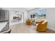 Bright sitting room featuring neutral walls, wood floors, and a view of the canal through large picture windows at 2401 Roberta Ln, Clearwater, FL 33764