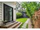 Backyard of the house featuring a patio, shed, natural landscaping, and manicured stone pathway in the corner at 2412 W Prospect Rd, Tampa, FL 33629