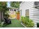 Cozy backyard area with artificial turf and a vibrant mural adding a unique, artistic touch at 2412 W Prospect Rd, Tampa, FL 33629