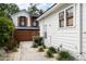 Backyard view of two-story home with white siding, black trim, and a landscaped yard at 2412 W Prospect Rd, Tampa, FL 33629