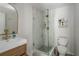 Modern bathroom featuring a glass enclosed shower, neutral tile, modern fixtures, and a contemporary sink basin at 2412 W Prospect Rd, Tampa, FL 33629