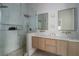 Contemporary bathroom with dual sinks, wood cabinets, a glass-enclosed shower with sleek fixtures at 2412 W Prospect Rd, Tampa, FL 33629