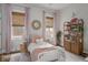 Charming bedroom with pink accents, a white iron bed frame, and a whimsical decorative mirror at 2412 W Prospect Rd, Tampa, FL 33629