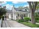 Charming traditional home featuring a welcoming front porch and meticulously landscaped front yard at 2412 W Prospect Rd, Tampa, FL 33629