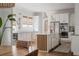Modern white kitchen with stainless steel appliances, a center island with seating, and plenty of cabinet space at 2412 W Prospect Rd, Tampa, FL 33629