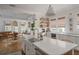 Open kitchen with a large island, white countertops, stainless steel appliances, and seamless flow into the dining area at 2412 W Prospect Rd, Tampa, FL 33629
