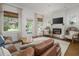 Spacious living room with large windows, a comfortable leather couch, and stylish decor at 2412 W Prospect Rd, Tampa, FL 33629