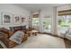 Cozy living room with a leather sofa, warm wood floors, and an inviting atmosphere with natural light at 2412 W Prospect Rd, Tampa, FL 33629