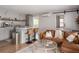 Open-concept living room with a breakfast bar and a modern couch with a glass coffee table and sliding barn door at 2412 W Prospect Rd, Tampa, FL 33629