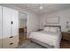 Comfortable bedroom with a plush bed, ceiling fan, neutral colors, and easy access to the combined living room and kitchen at 2412 W Prospect Rd, Tampa, FL 33629