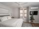 Bright bedroom with a cozy bed, stylish window, and a mounted TV for entertainment with neutral colors for relaxation at 2412 W Prospect Rd, Tampa, FL 33629