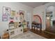 Spacious playroom featuring a toy kitchen, play area, and a view to a dining area at 2412 W Prospect Rd, Tampa, FL 33629