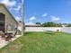 Spacious backyard featuring a hammock, lush green grass, and a clean white fence for privacy at 24811 Gun Smoke Dr, Land O Lakes, FL 34639