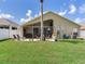 Expansive backyard with a covered patio, perfect for outdoor entertaining and relaxation at 24811 Gun Smoke Dr, Land O Lakes, FL 34639