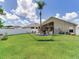 Spacious backyard featuring a lush lawn and outdoor seating, creating a perfect space for relaxation and entertainment at 24811 Gun Smoke Dr, Land O Lakes, FL 34639