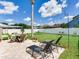 Backyard patio with lounge chairs and outdoor seating at 24811 Gun Smoke Dr, Land O Lakes, FL 34639
