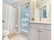 Bathroom showcasing a modern vanity and glass door to the backyard at 24811 Gun Smoke Dr, Land O Lakes, FL 34639