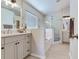 Bright bathroom with double vanity, soaking tub, glass shower, and modern finishes at 24811 Gun Smoke Dr, Land O Lakes, FL 34639