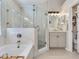 Modern bathroom with a soaking tub, a glass-enclosed shower, and a sleek vanity at 24811 Gun Smoke Dr, Land O Lakes, FL 34639
