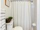 Bathroom with decorative shower curtain and neutral color scheme at 24811 Gun Smoke Dr, Land O Lakes, FL 34639
