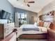 Charming bedroom with a decorative wall, a ceiling fan, and a view of the backyard at 24811 Gun Smoke Dr, Land O Lakes, FL 34639